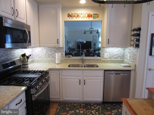 11200 Scottwood Ln N, Fredericksburg, VA 22407 - kitchen with stainless steel appliances, a sink, decorative backsplash, and white cabinetry