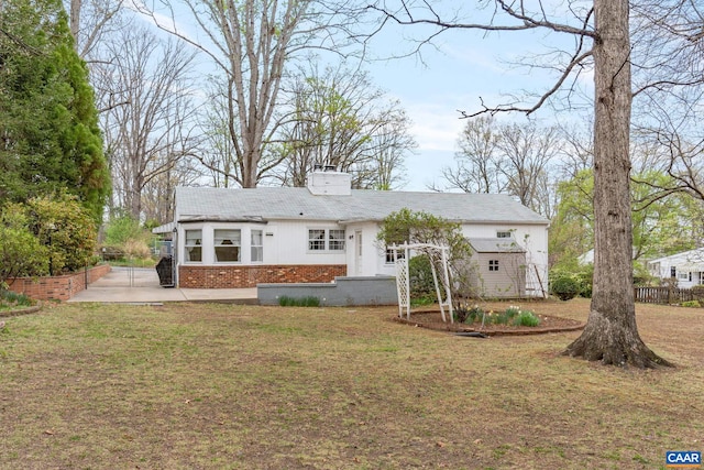 129 W Park Dr, Charlottesville, VA 22901 - view of front of property with a chimney, a front yard, and brick siding