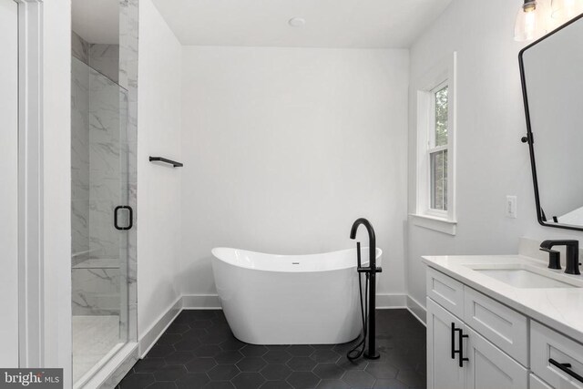 9435 Signature Way, Fredericksburg, VA 22407 - bathroom featuring baseboards, a marble finish shower, vanity, and a freestanding tub