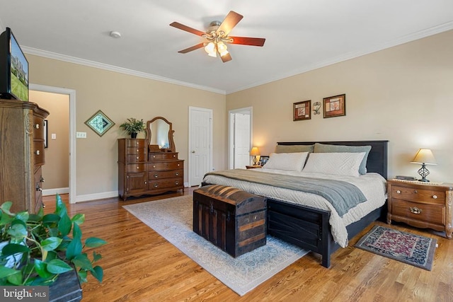  - bedroom featuring wood finished floors, crown molding, and ceiling fan