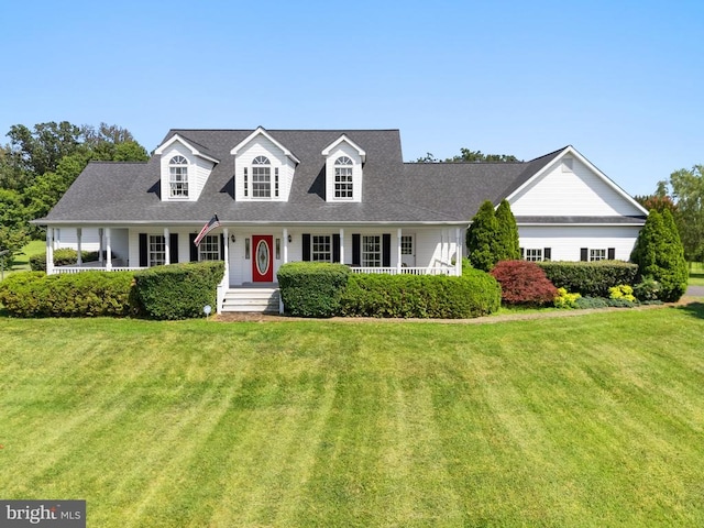  - cape cod house with a porch, a front yard, and a shingled roof
