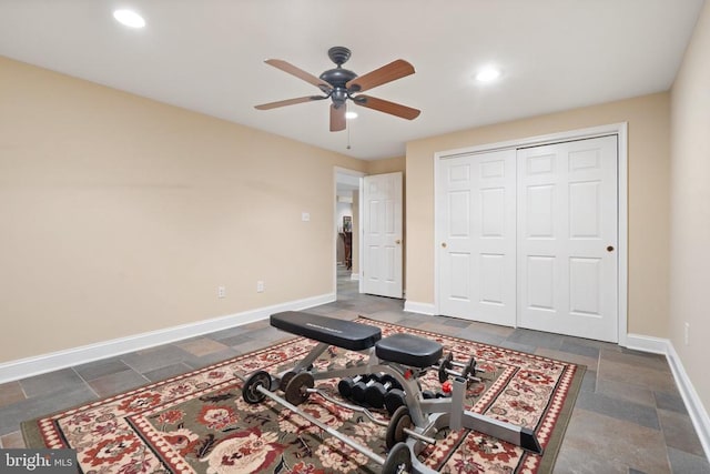  - exercise room featuring ceiling fan, stone tile floors, and recessed lighting