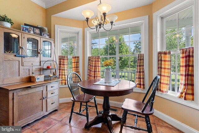  - dining room with a chandelier, light tile patterned flooring, and crown molding