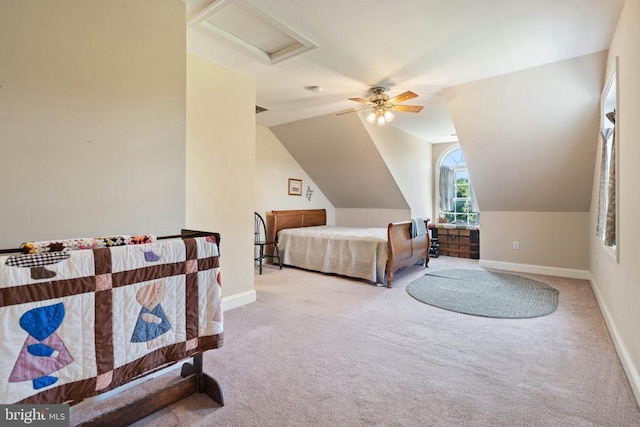  - bedroom featuring carpet, attic access, vaulted ceiling, and a ceiling fan
