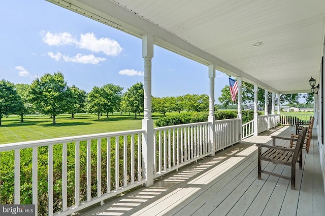  - porch featuring a yard