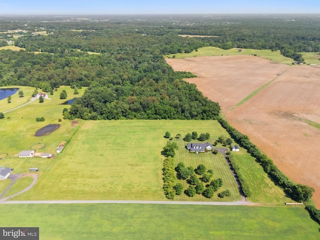  - aerial view of sparsely populated area featuring a heavily wooded area