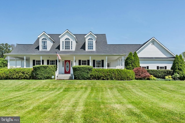  - cape cod-style house featuring a front yard and covered porch