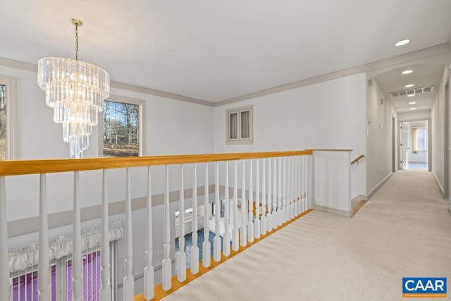 corridor with an inviting chandelier, plenty of natural light, visible vents, and recessed lighting