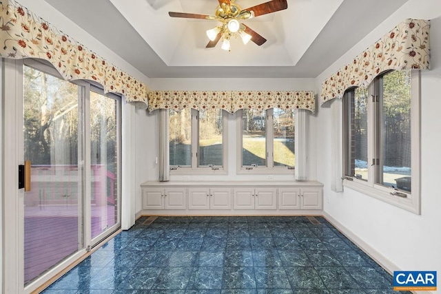 unfurnished sunroom featuring a raised ceiling