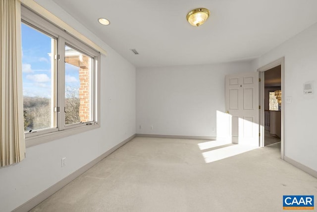 empty room with light carpet, baseboards, and visible vents