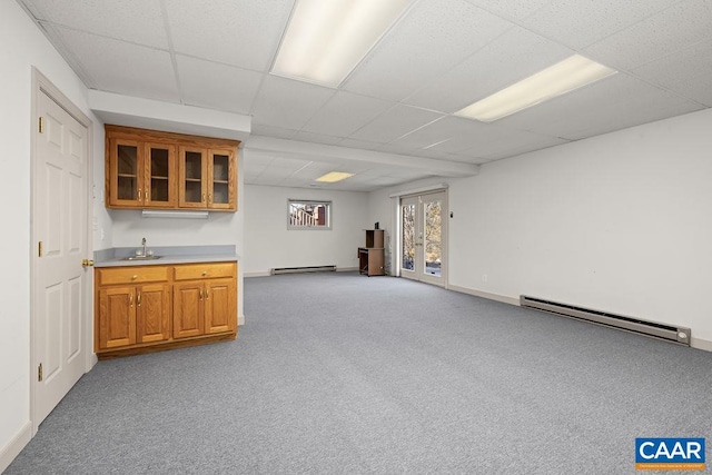 bar with a sink, a baseboard heating unit, light carpet, baseboard heating, and a drop ceiling