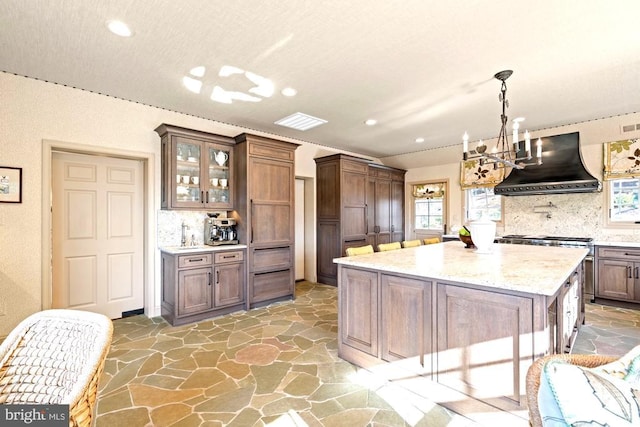 1126 F T Valley Rd, Sperryville, VA 22740 - kitchen with custom exhaust hood, tasteful backsplash, a chandelier, recessed lighting, and stone flooring