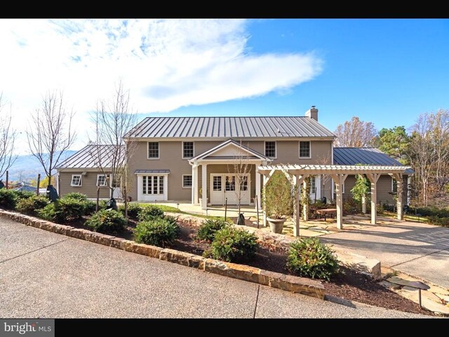 1126 F T Valley Rd, Sperryville, VA 22740 - view of front of house featuring metal roof, a pergola, a patio area, and a chimney
