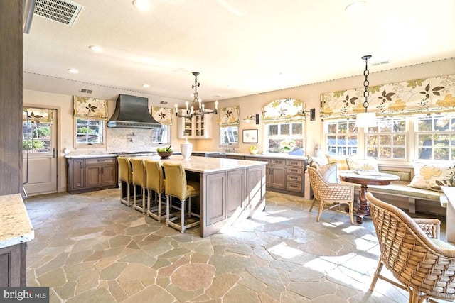 1126 F T Valley Rd, Sperryville, VA 22740 - kitchen with premium range hood, stone floors, a chandelier, recessed lighting, and a kitchen island