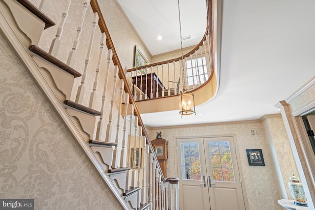 1126 F T Valley Rd, Sperryville, VA 22740 - stairway with crown molding, wallpapered walls, a chandelier, french doors, and a high ceiling