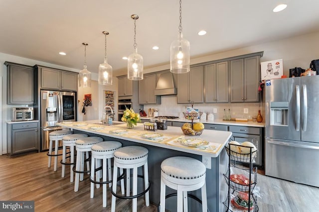 11726 Robin Woods Cir, Spotsylvania, VA 22551 - kitchen featuring appliances with stainless steel finishes, custom exhaust hood, gray cabinetry, light countertops, and recessed lighting