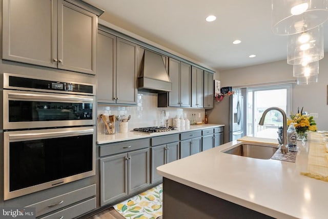 11726 Robin Woods Cir, Spotsylvania, VA 22551 - kitchen with stainless steel appliances, gray cabinets, custom exhaust hood, a sink, and light countertops