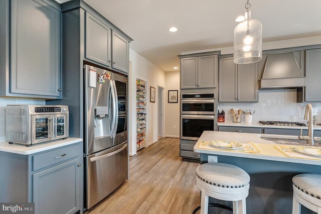 11726 Robin Woods Cir, Spotsylvania, VA 22551 - kitchen featuring stainless steel appliances, gray cabinets, custom exhaust hood, backsplash, and recessed lighting