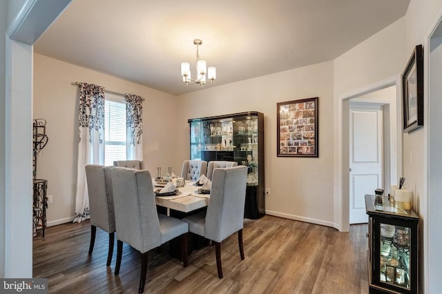 11726 Robin Woods Cir, Spotsylvania, VA 22551 - dining space with a chandelier, wood finished floors, and baseboards