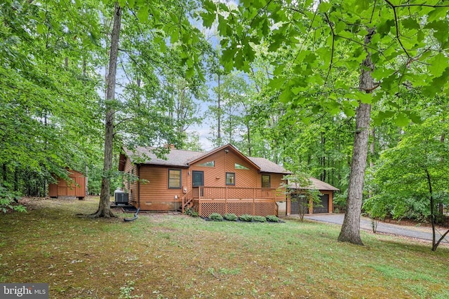 340 Wilson St, Bumpass, VA 23024 - back of house featuring roof with shingles, an outdoor structure, driveway, a garage, and cooling unit