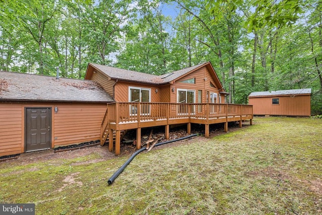 340 Wilson St, Bumpass, VA 23024 - rear view of house with a yard, an outbuilding, roof with shingles, and a wooden deck