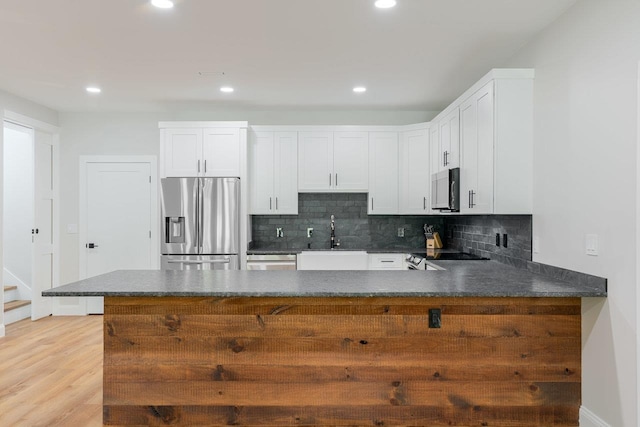 10 Samuel Bears Rd, Weyers Cave, VA 24486 - kitchen with stainless steel fridge with ice dispenser, a sink, a peninsula, backsplash, and recessed lighting