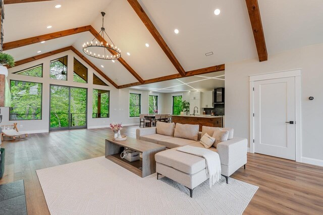 10 Samuel Bears Rd, Weyers Cave, VA 24486 - living area featuring high vaulted ceiling, beamed ceiling, baseboards, light wood-style floors, and a chandelier