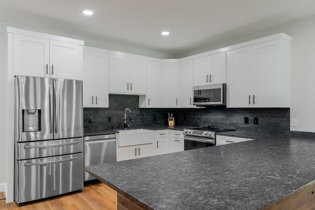 10 Samuel Bears Rd, Weyers Cave, VA 24486 - kitchen with stainless steel appliances, a peninsula, a sink, white cabinets, and recessed lighting