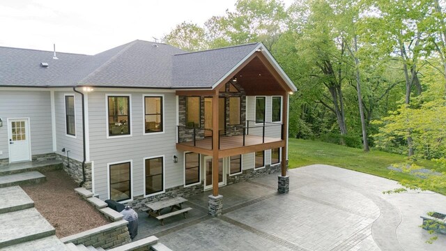 10 Samuel Bears Rd, Weyers Cave, VA 24486 - rear view of property with stone siding, a patio area, a balcony, a shingled roof, and a yard