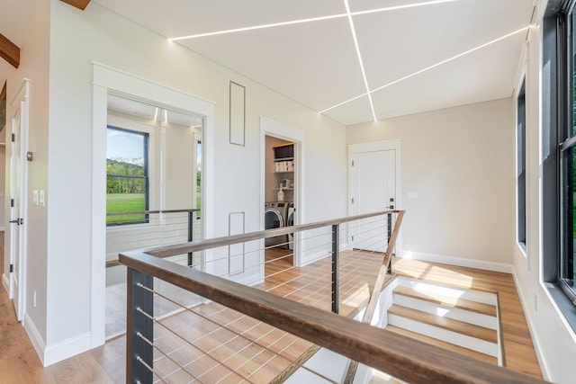 10 Samuel Bears Rd, Weyers Cave, VA 24486 - corridor featuring washing machine and dryer, an upstairs landing, light wood-style floors, and baseboards
