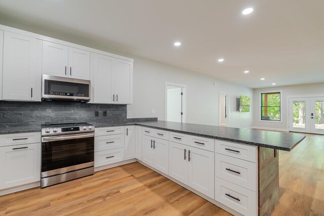 10 Samuel Bears Rd, Weyers Cave, VA 24486 - kitchen featuring stainless steel appliances, a peninsula, recessed lighting, light wood-type flooring, and decorative backsplash
