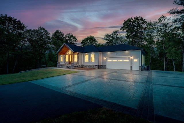 10 Samuel Bears Rd, Weyers Cave, VA 24486 - view of front of house featuring an attached garage, driveway, a lawn, and stone siding
