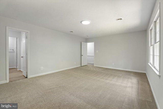carpeted spare room with baseboards