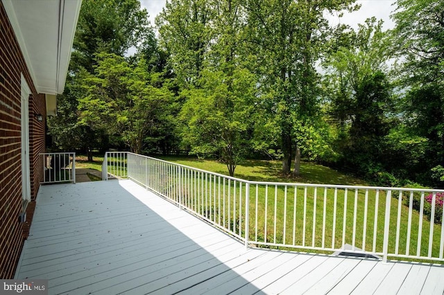 wooden terrace with a lawn