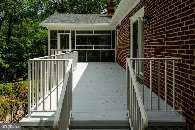 wooden terrace featuring a sunroom