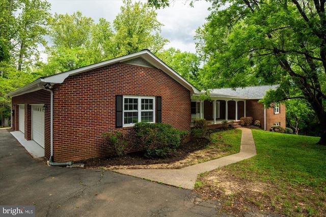 view of side of property with a yard and brick siding