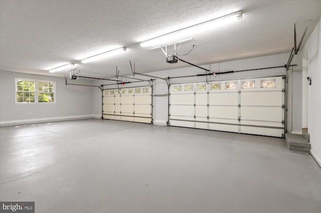 garage with a garage door opener and baseboards