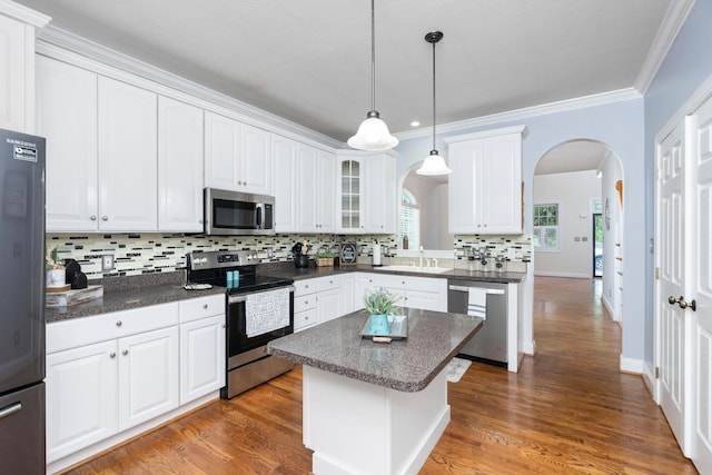 47 Villa View Dr, Staunton, VA 24401 - kitchen featuring stainless steel appliances, arched walkways, a sink, decorative backsplash, and white cabinets