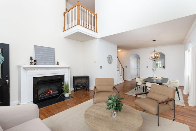 47 Villa View Dr, Staunton, VA 24401 - living area featuring arched walkways, stairs, wood finished floors, and crown molding