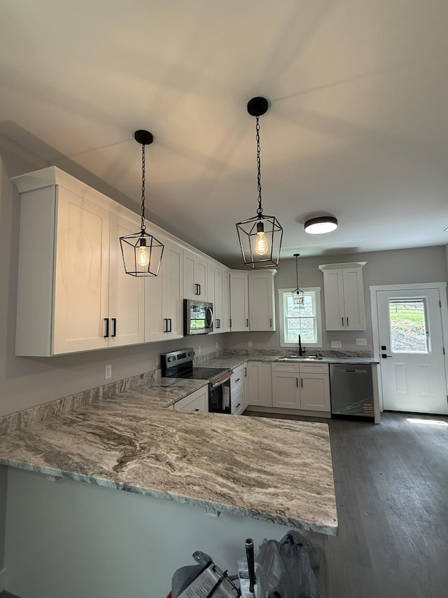 1522 2nd St, Waynesboro, VA 22980 - kitchen with stainless steel appliances, wood finished floors, white cabinets, pendant lighting, and light stone countertops