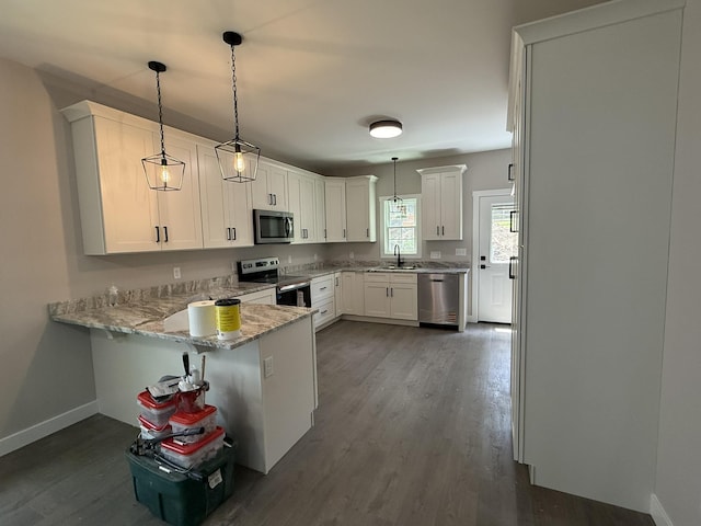 1522 2nd St, Waynesboro, VA 22980 - kitchen with stainless steel appliances, a peninsula, light stone countertops, dark wood-style flooring, and white cabinets
