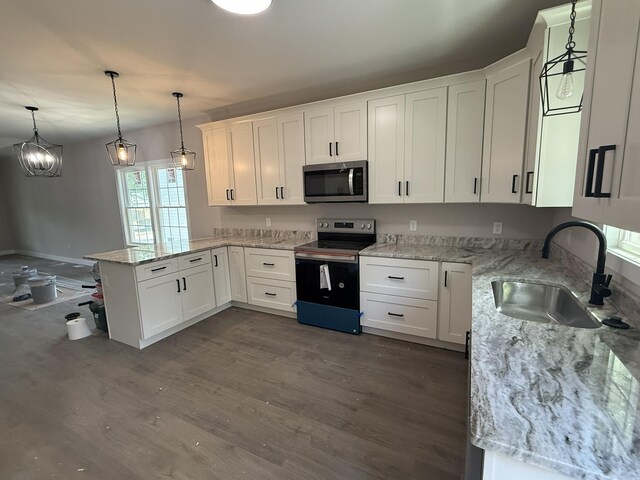 1522 2nd St, Waynesboro, VA 22980 - kitchen with stainless steel appliances, a peninsula, white cabinetry, and dark wood-style flooring