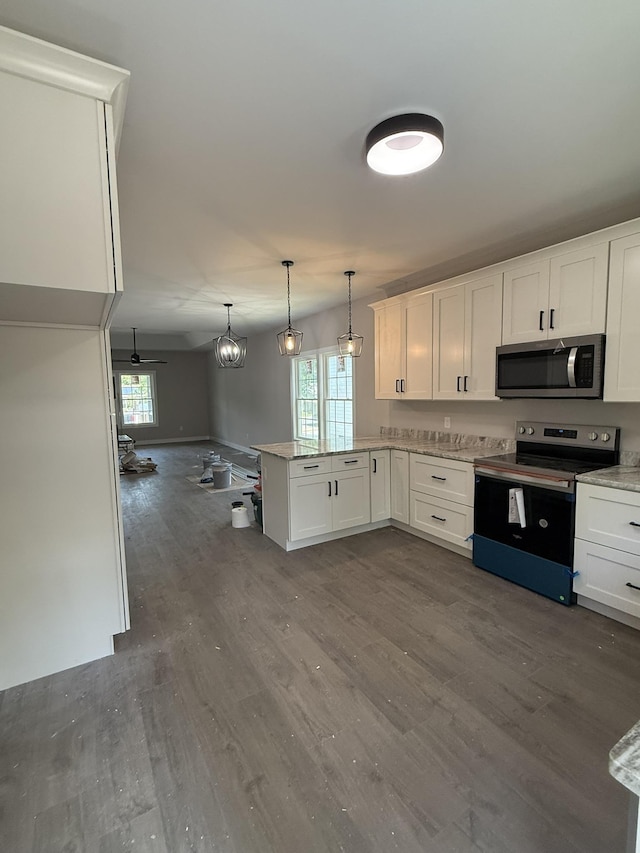 1522 2nd St, Waynesboro, VA 22980 - kitchen featuring appliances with stainless steel finishes, a peninsula, dark wood finished floors, white cabinetry, and healthy amount of natural light