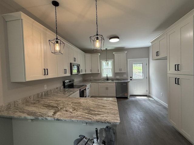 1522 2nd St, Waynesboro, VA 22980 - kitchen featuring stainless steel appliances, a peninsula, dark wood finished floors, white cabinets, and decorative light fixtures