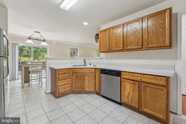 10108 Chesney Dr, Spotsylvania, VA 22553 - kitchen featuring appliances with stainless steel finishes, a sink, light countertops, brown cabinets, and light tile patterned floors