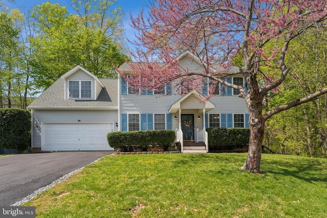 10108 Chesney Dr, Spotsylvania, VA 22553 - view of front facade with asphalt driveway, a front lawn, and roof with shingles