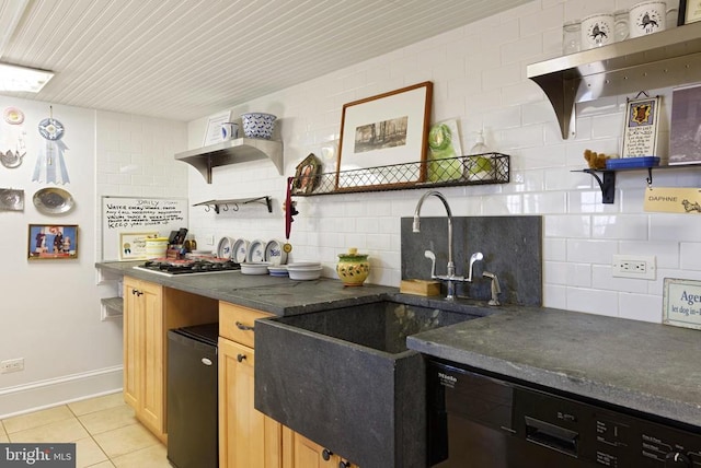  - kitchen with open shelves, dark countertops, light tile patterned floors, and a sink