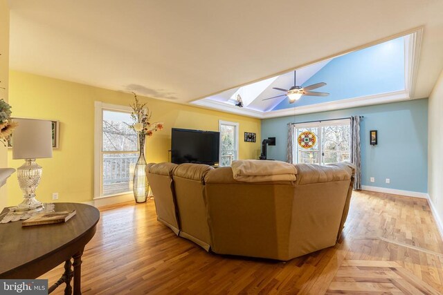 689 Mutton Hollow Rd, Stanardsville, VA 22973 - living area featuring a skylight, ceiling fan, baseboards, and light wood-style floors
