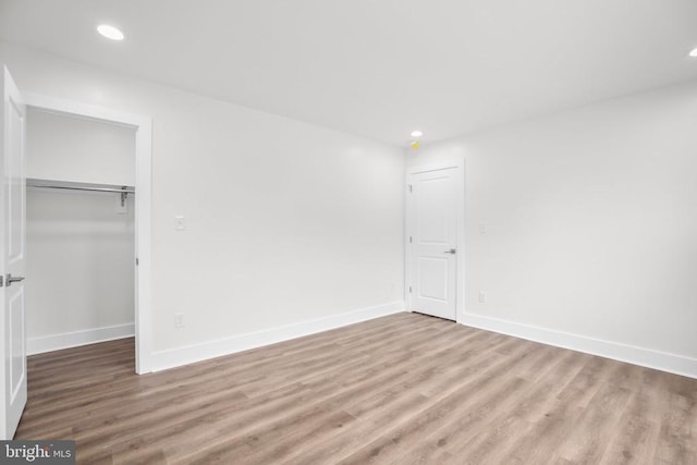 10302 Laurel Ridge Way, Fredericksburg, VA 22408 - unfurnished bedroom with wood finished floors, recessed lighting, a closet, baseboards, and a spacious closet