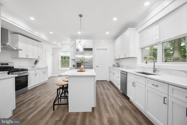 10302 Laurel Ridge Way, Fredericksburg, VA 22408 - kitchen with stainless steel appliances, wall chimney range hood, crown molding, white cabinets, and dark wood-style flooring